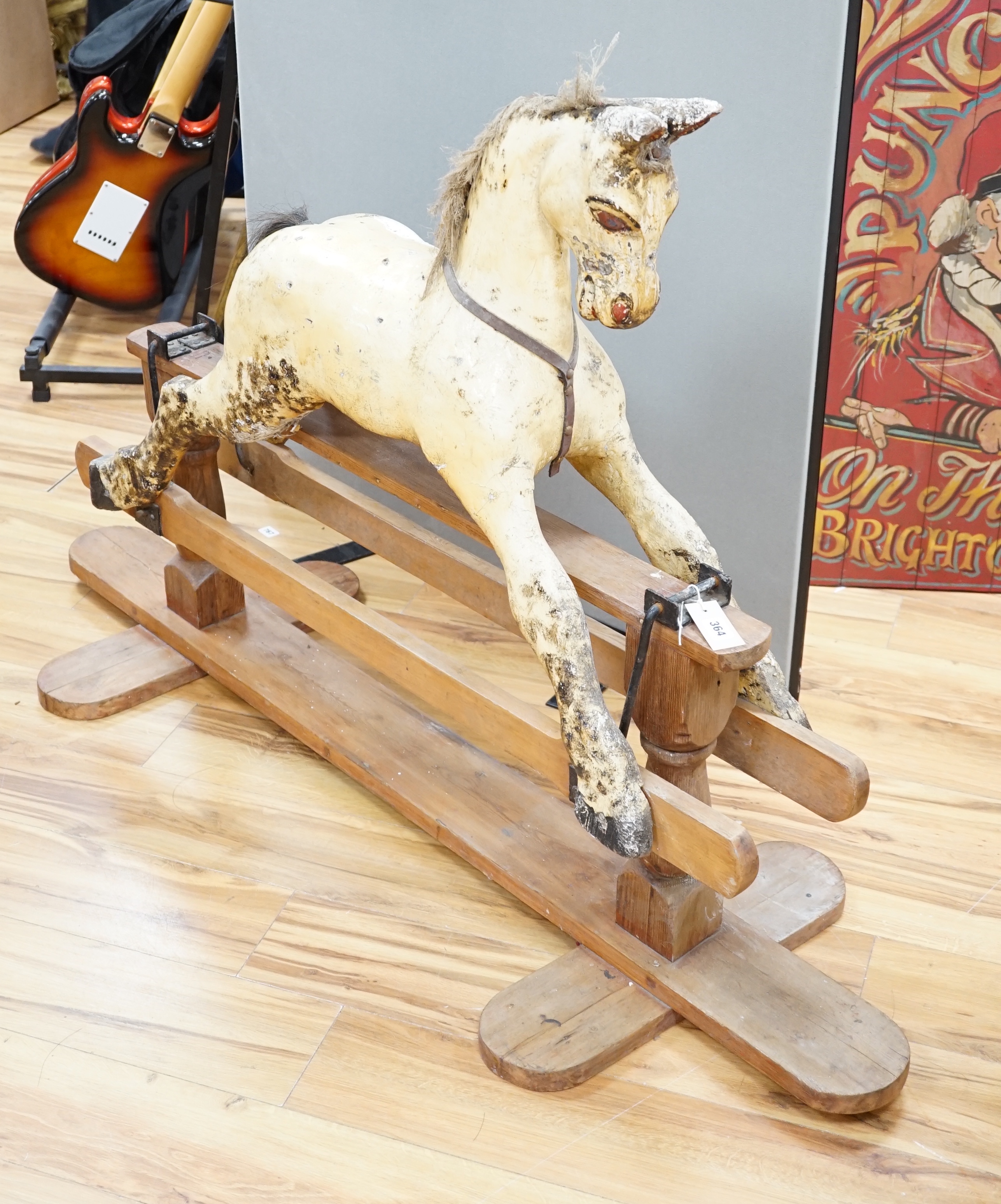 A Rocking horse on a wooden pedestal rocker, with plaster, composite body, height, 97cm, length 152cm